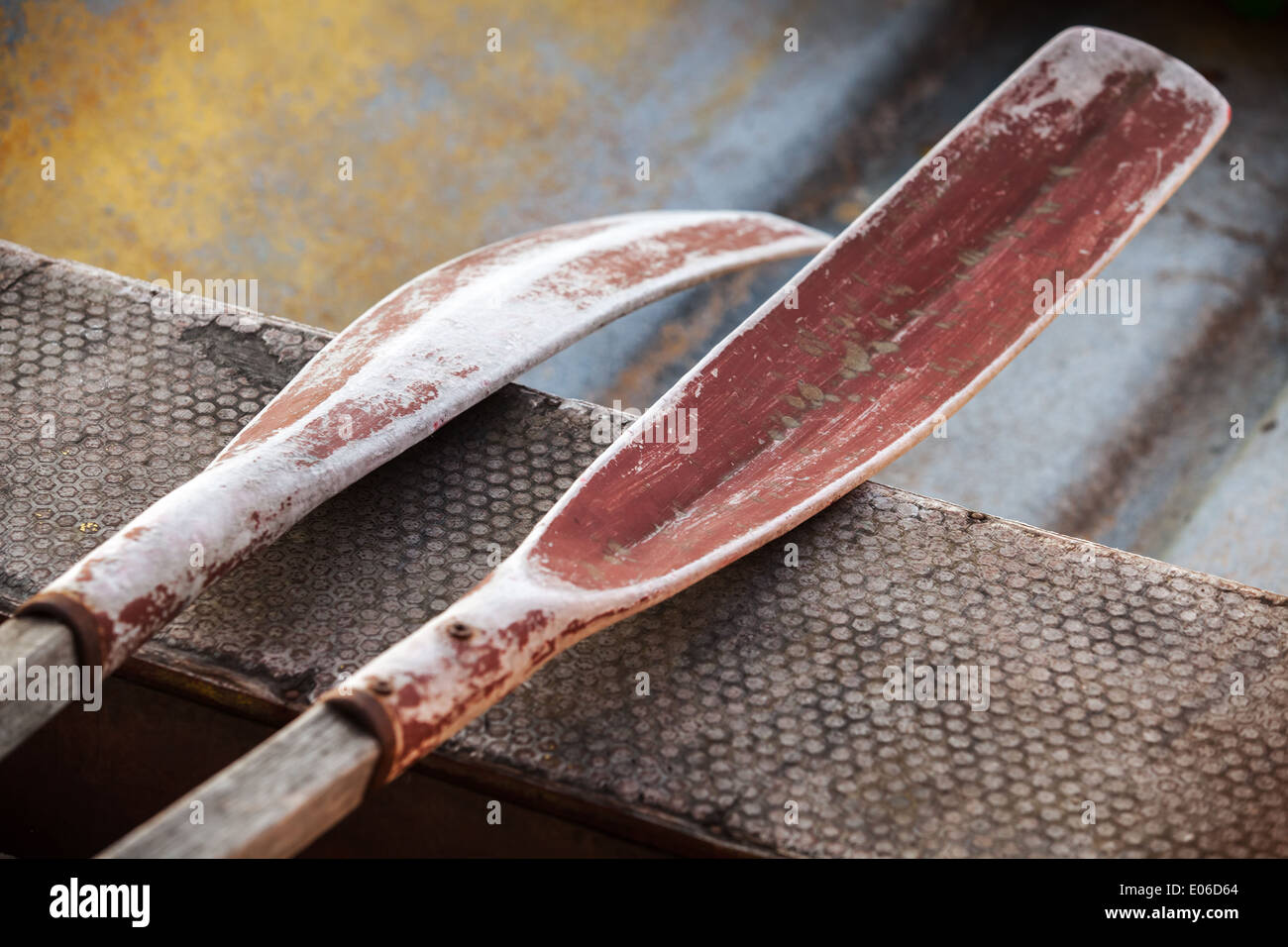 Old oars lie in small fishing boat Stock Photo