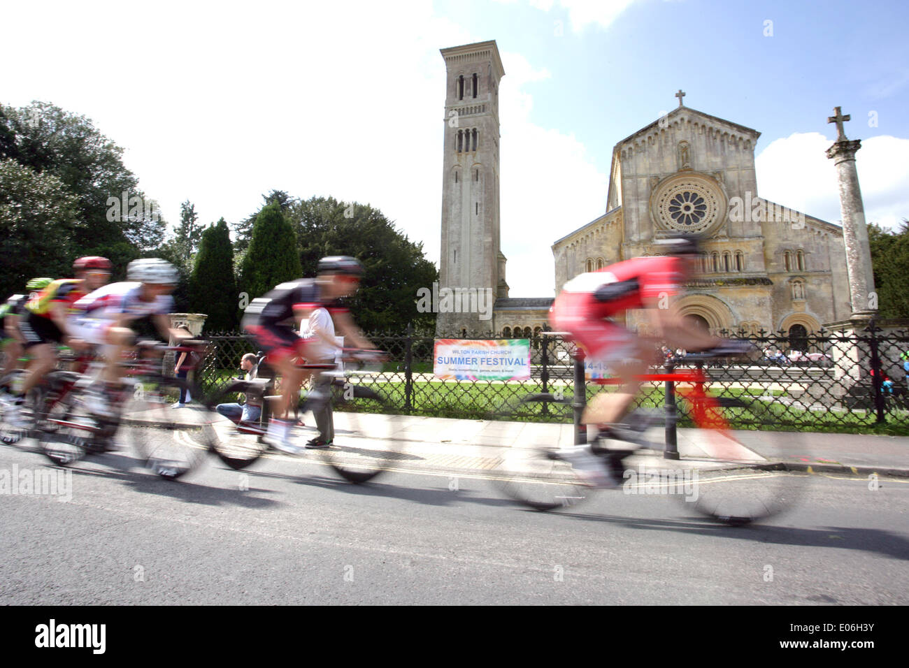 Wilton, UK. 04th May, 2014. LEADING professional cyclists competing in the Cycle Willtshire Grand Prix pass the Italianate Church of St Mary and St Nicholas in Wilton, England, on Sunday 4th May 2014. The Wiltshire Grand Prix is an Elite Cycle Race, covering 101miles/160km through the Wilshire countryside, and is part of the top tier of the British Cycling Calendar attracting top level professional riders in the UK. Credit:  Parkes Photographic Archive/Alamy Live News Stock Photo