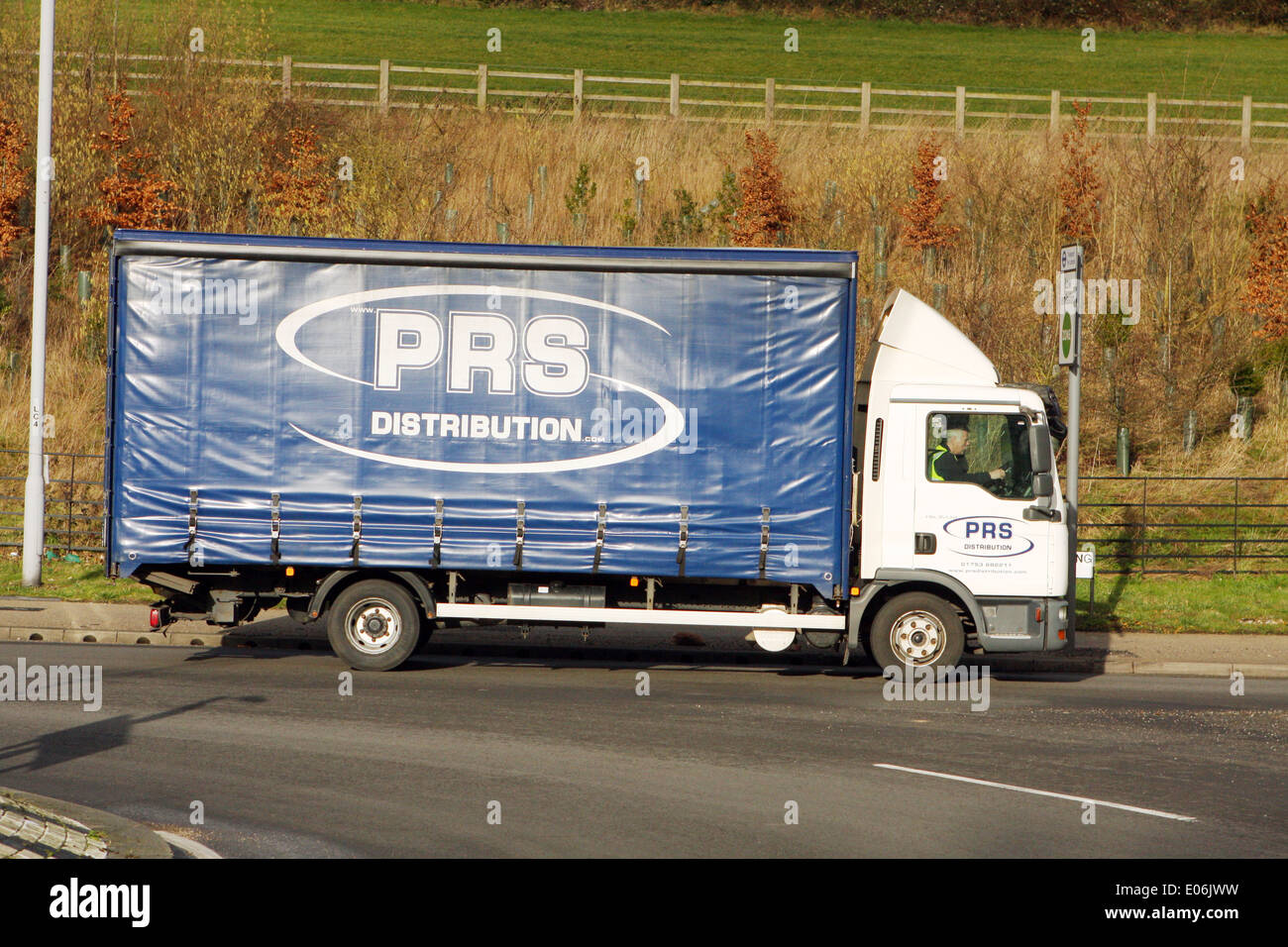 A PRS Distribution truck exiting a roundabout in Coulsdon, Surrey, England Stock Photo