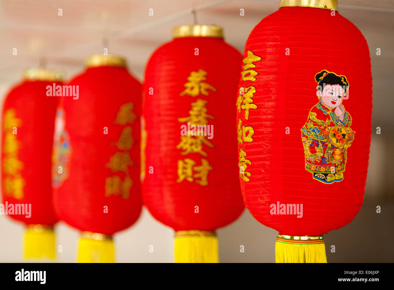 Typical generic chinese lanterns found in chinese restaurants all over the world. They are red with yellow tassels Stock Photo