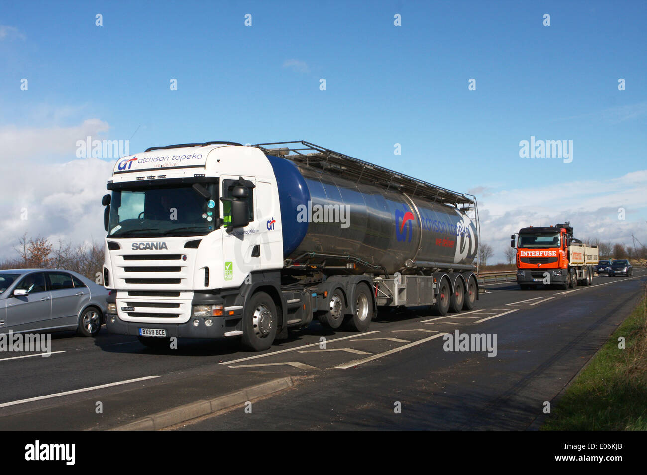Trucks and a car traveling on the A46 dual carriageway in Leicestershire, England. Stock Photo