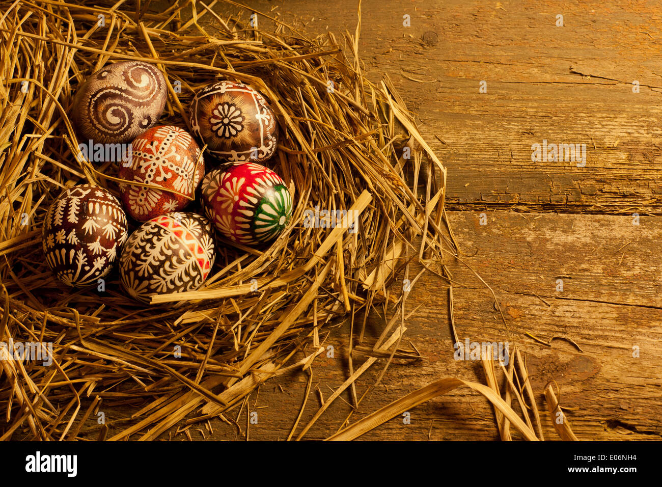 Easter eggs in nest on wooden table Stock Photo