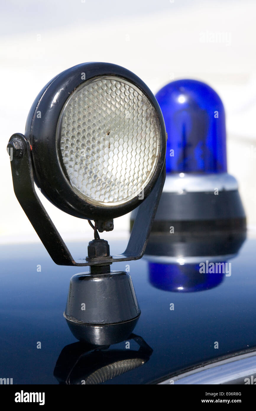 Spot Light and Blue police light on old classic Police car Stock Photo