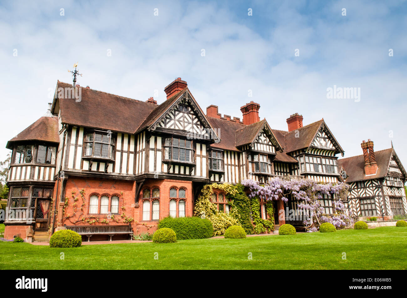 View of the stunning National Trust-owned Wightwick Manor, in Wolverhampton, with beautiful flowering wisteria covering windows Stock Photo