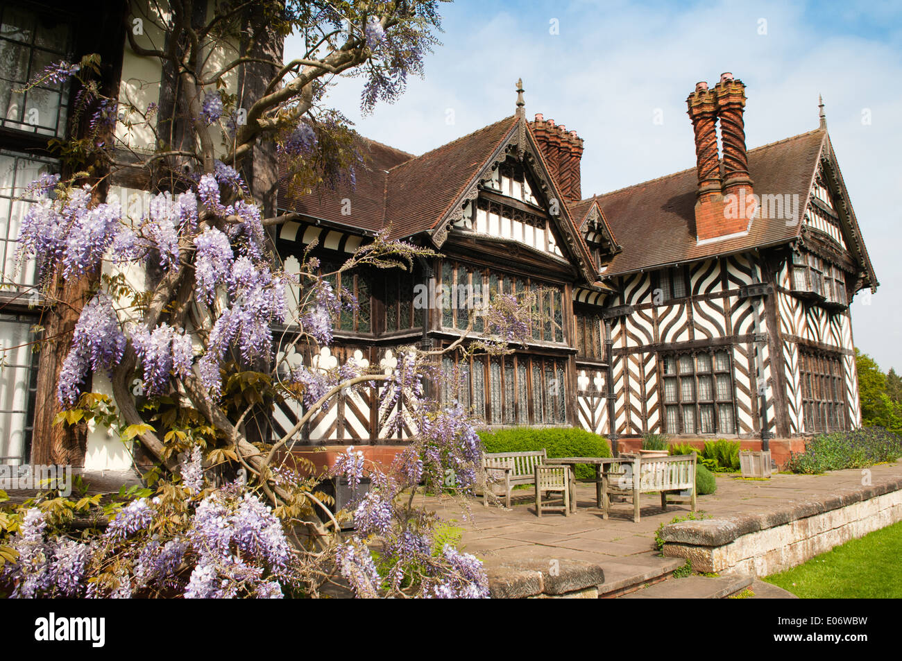 View of the National Trust-owned Wightwick Manor, in Wolverhampton, with beautiful flowering wisteria towards the East wing Stock Photo