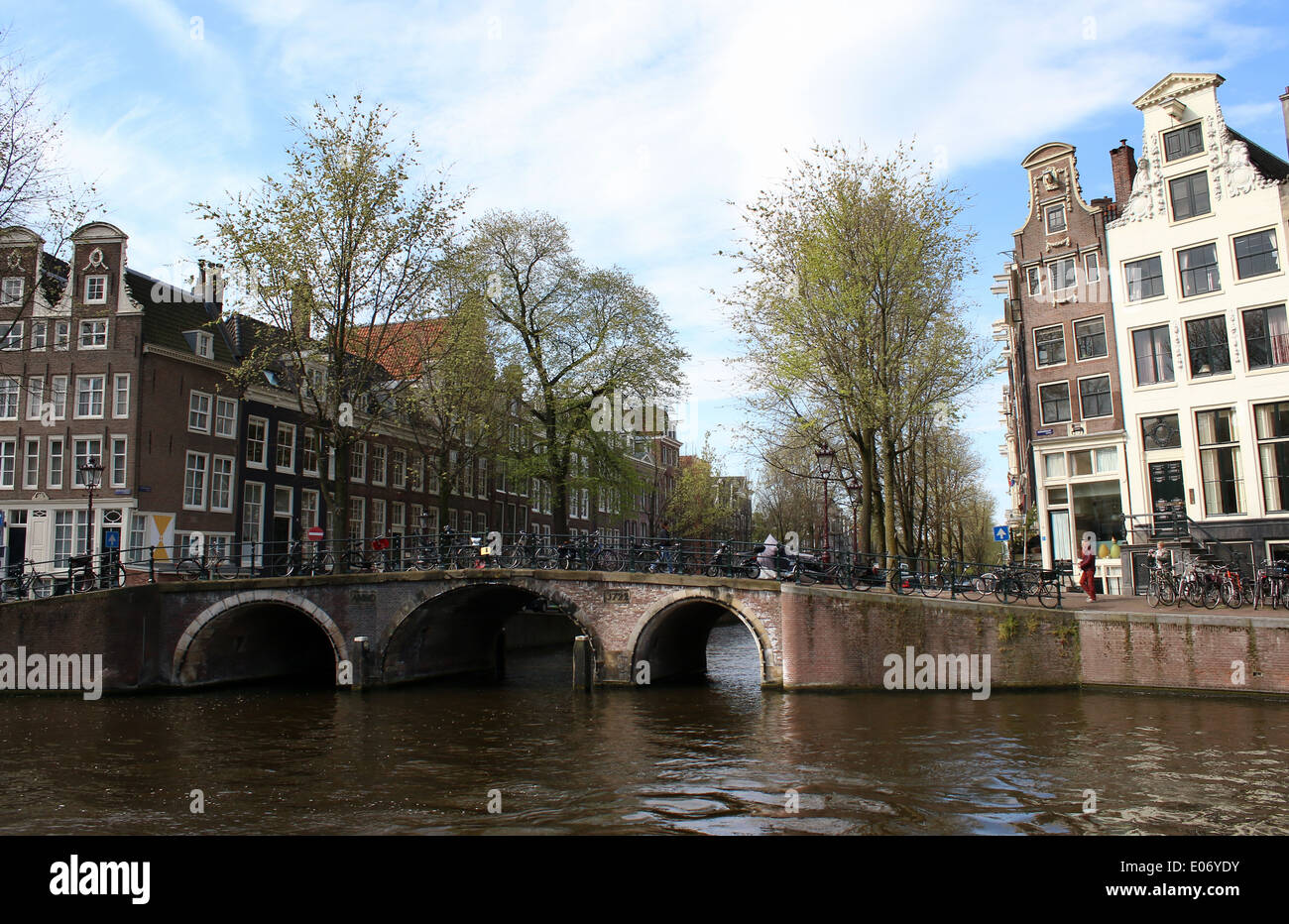 Old stone city bridge at the junction of Herengracht and Leidsegracht canal in Amsterdam (stictched panorama) Stock Photo