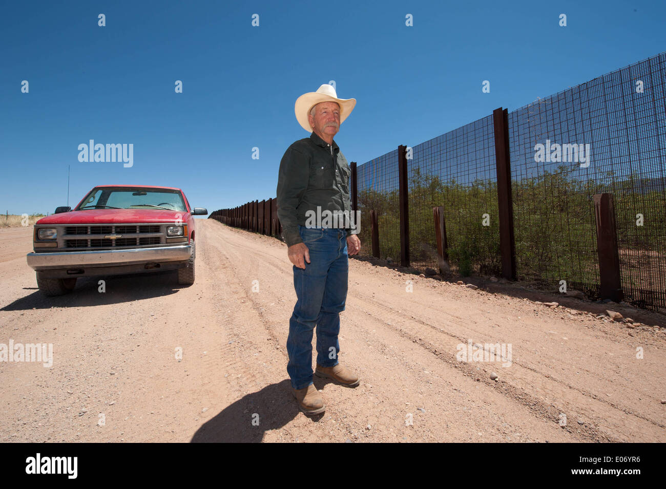 Naco, Arizona, USA. 28th Apr, 2014. Arizona cattle rancher JOHN LADD's ranch near Naco, Ariz., abuts the border fence separating the U.S. and Mexico. Over the years he's had problems caused by both smugglers and U.S. Border Patrol agents including damage to his property, livestock and grass. © Will Seberger/ZUMAPRESS.com/Alamy Live News Stock Photo