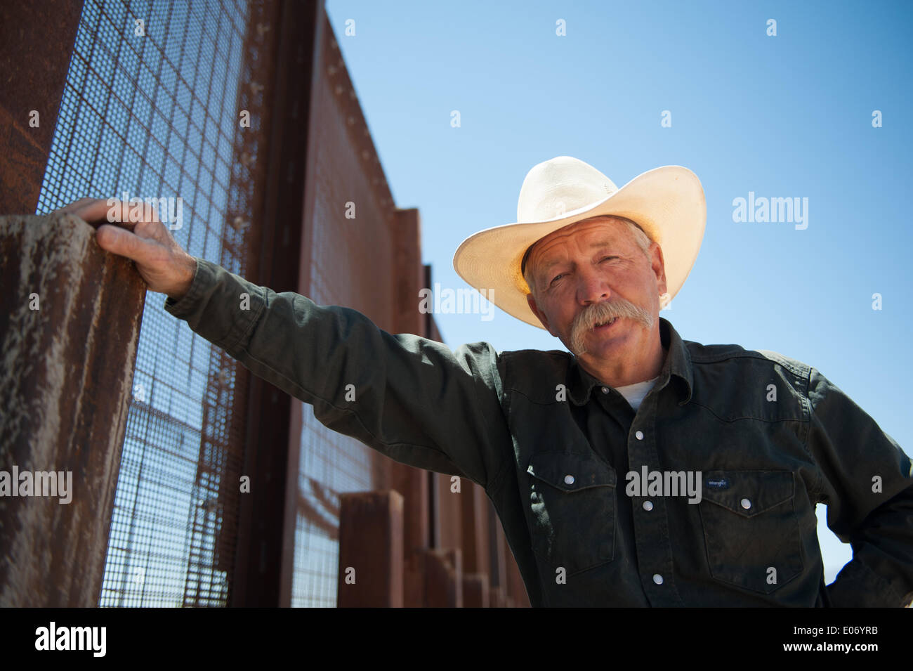 Naco, Arizona, USA. 28th Apr, 2014. Arizona cattle rancher JOHN LADD's ranch near Naco, Ariz., abuts the border fence separating the U.S. and Mexico. Over the years he's had problems caused by both smugglers and U.S. Border Patrol agents including damage to his property, livestock and grass. © Will Seberger/ZUMAPRESS.com/Alamy Live News Stock Photo