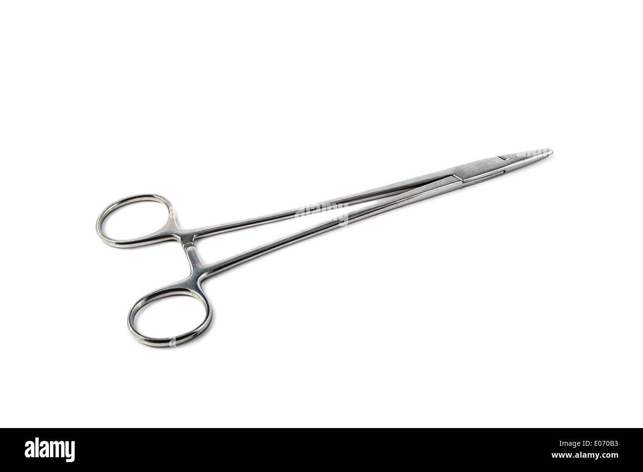 a pair of stainless steel surgical forceps over a white background Stock Photo