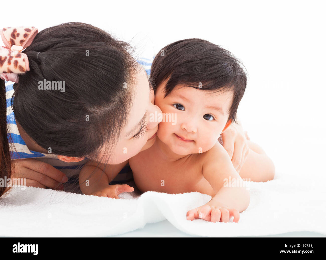 Happy mother kissing smiling child baby Stock Photo