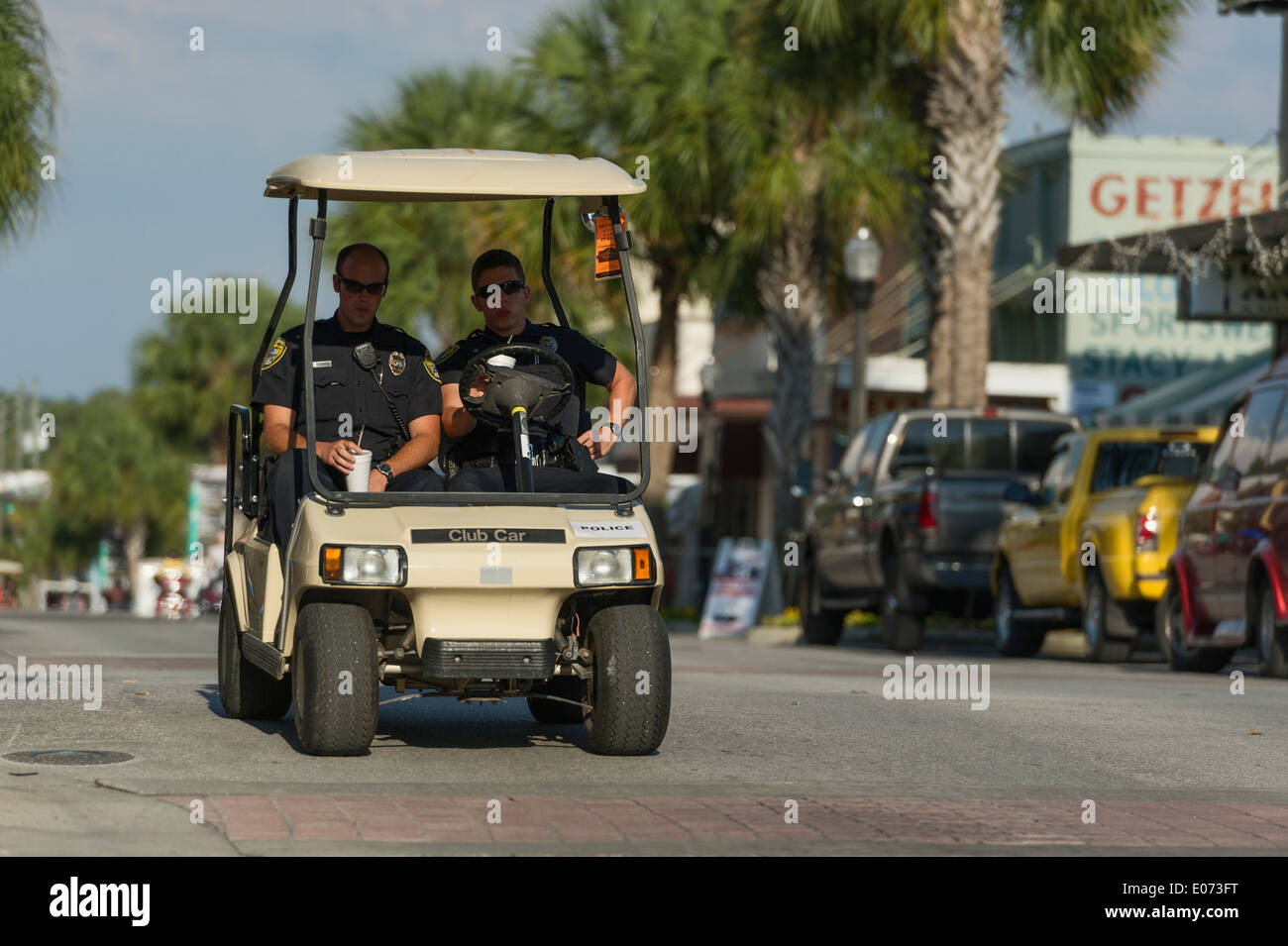 Leesburg Florida City Policemen riding in a golf cart patroling the City Streets. Stock Photo