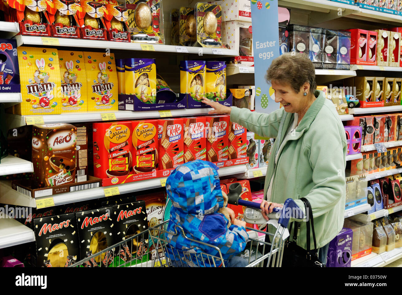 Grandmother and grandson shopping for easter eggs in Tesco Stock Photo