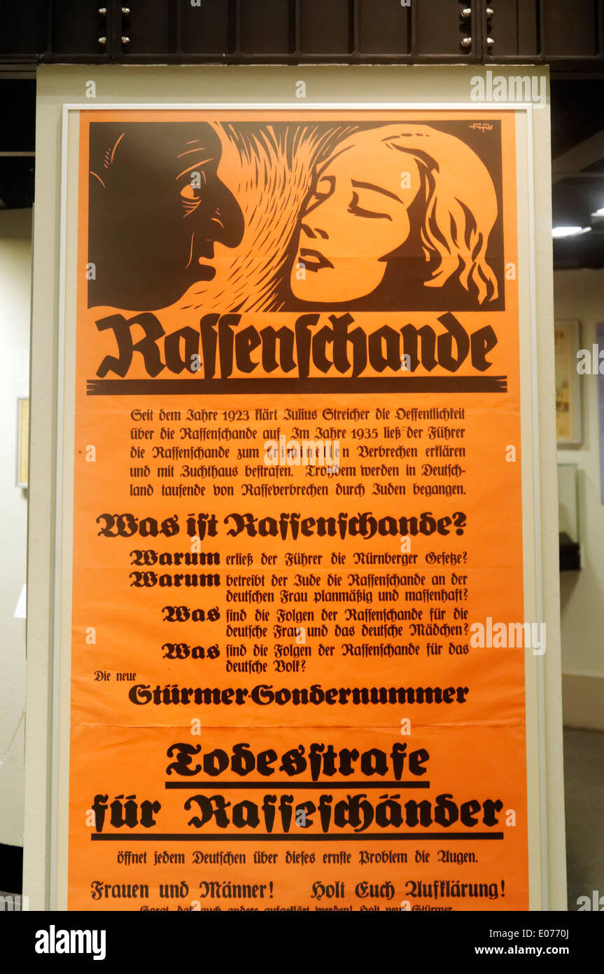 A nazi era poster showing the outline of a jew looking with lust at a blonde with the word "Rassenschande" or "Racial Defilement Stock Photo