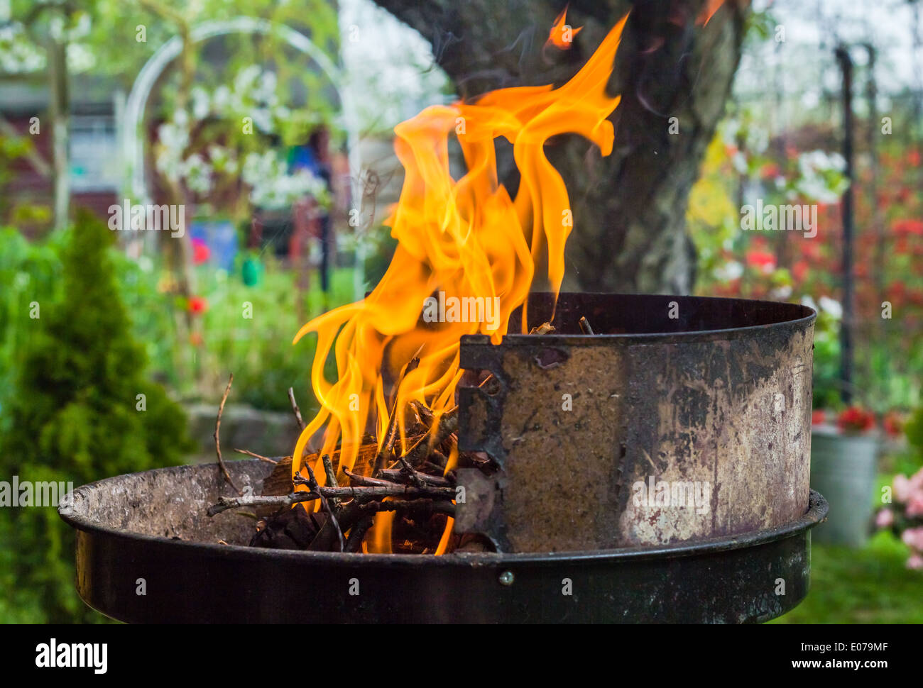 Lighting the fire during the spring barbecue in the garden Stock Photo