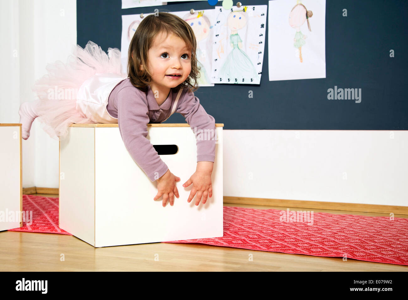Little girl wears a tutu playing in nursery Stock Photo