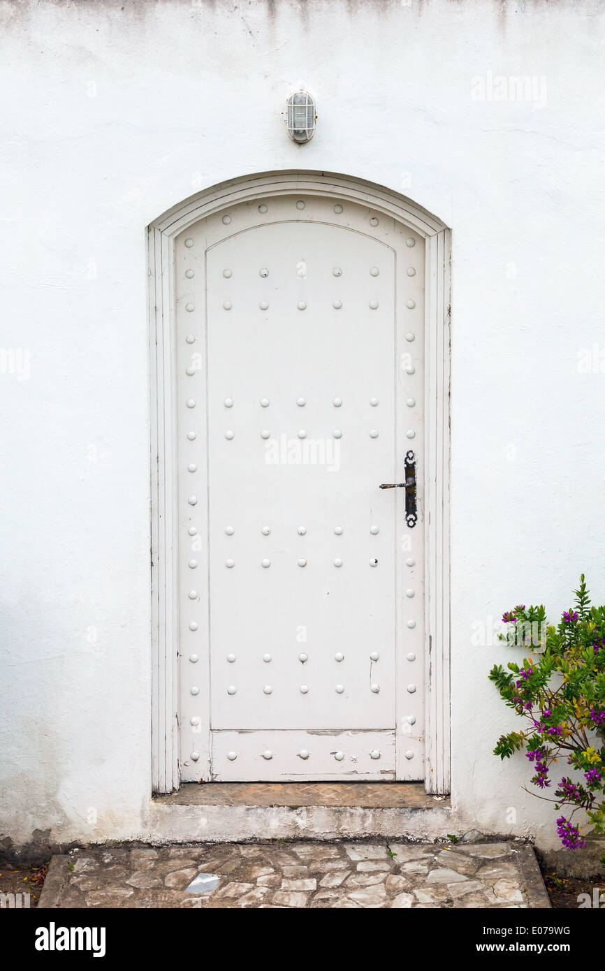 White wall and old wooden door. Background texture Stock Photo