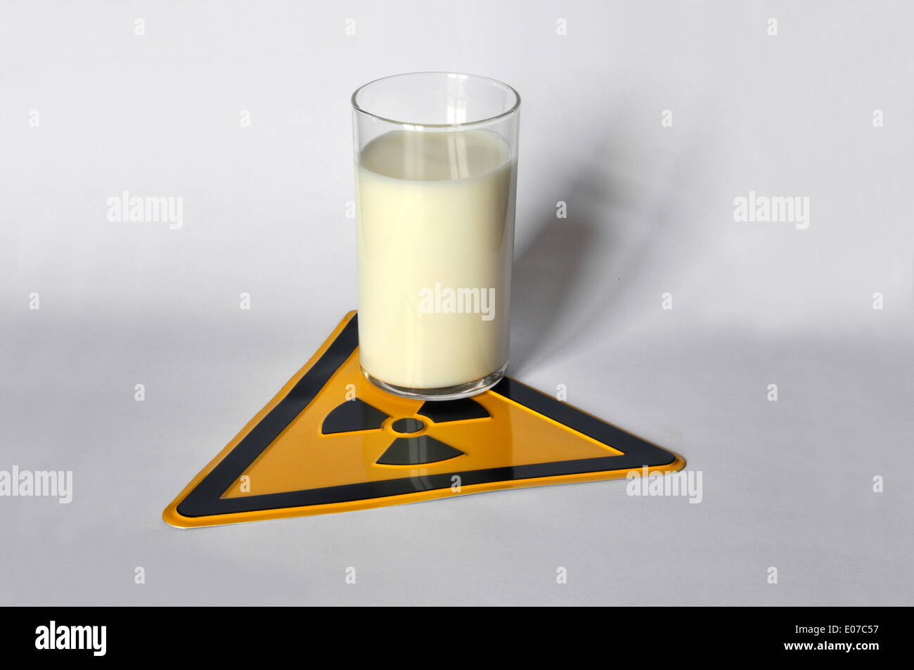(ILLUSTRATION) A glass of milk stands on a radioactivity warning sign