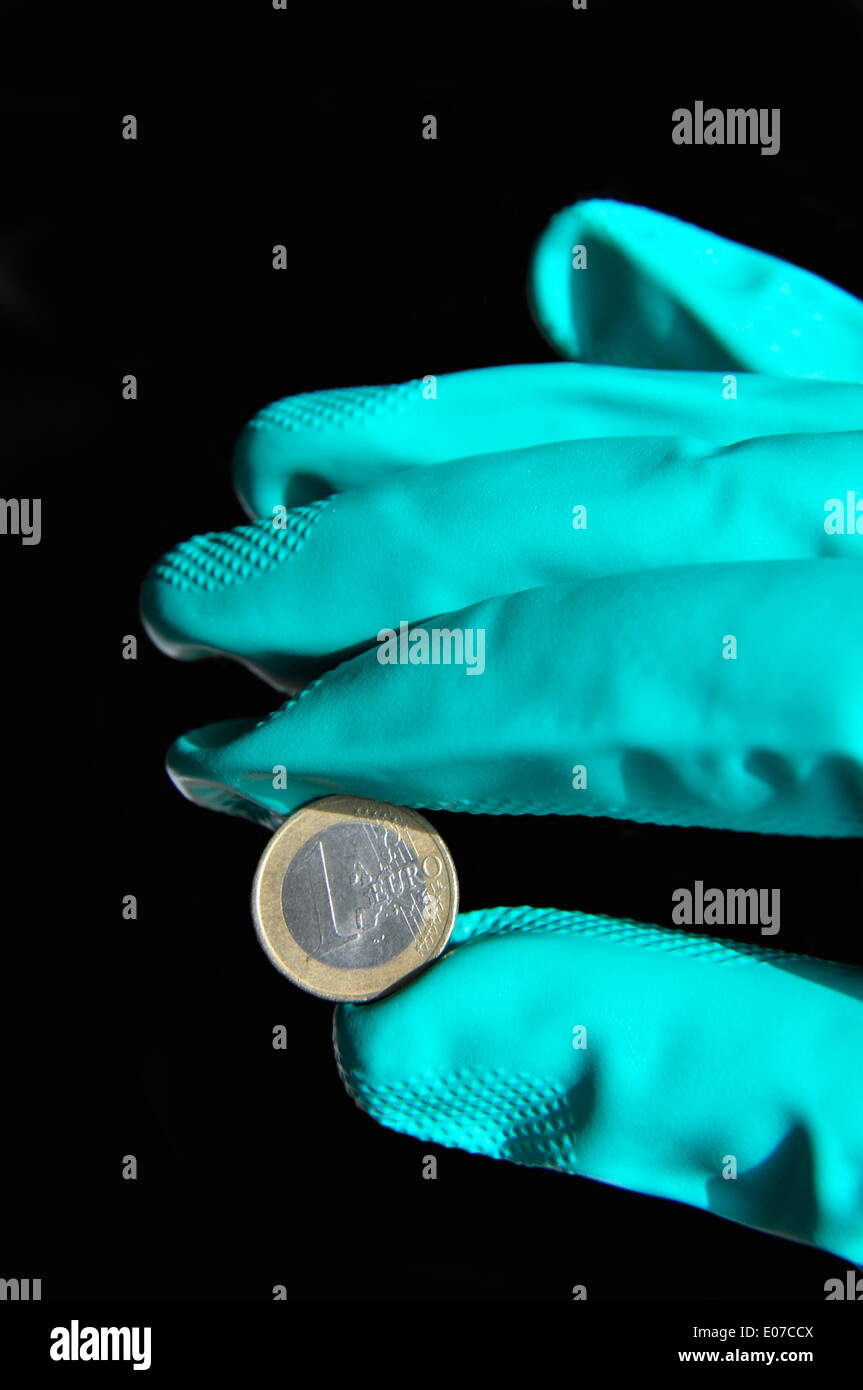 Illustration - a hand in a rubber glove holds a one euro coin in Germany, 08 October 2010. Fotoarchiv für Zeitgeschichte - NO WIRE SERVICE Stock Photo