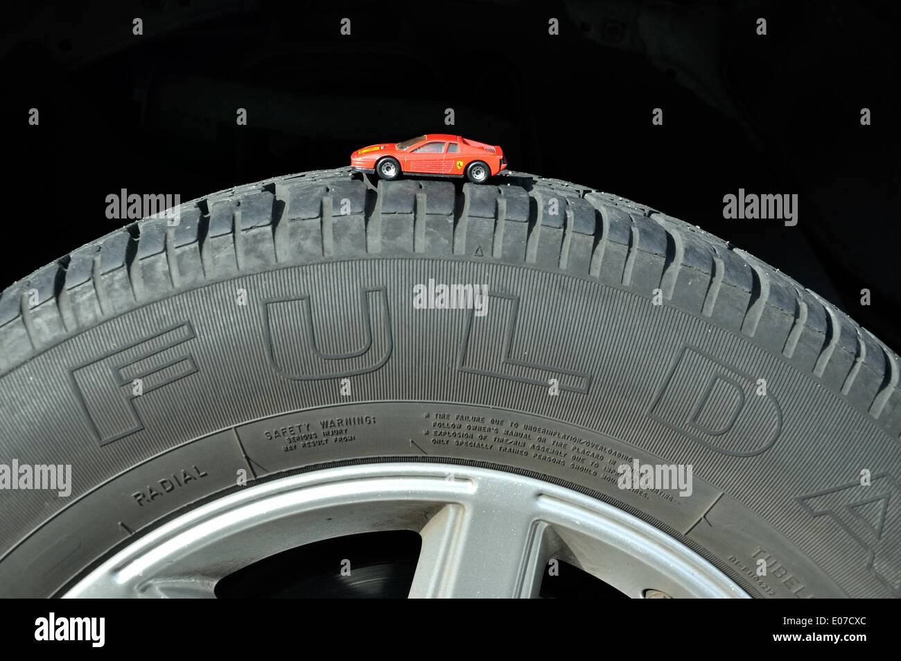 Illustration - A red Ferrari Matchbox car stands on a 'Fulda Reifen' tire in Germany, 08 October 2010. Photo: Berliner Verlag/Steinach - NO WIRE SERVICE Stock Photo