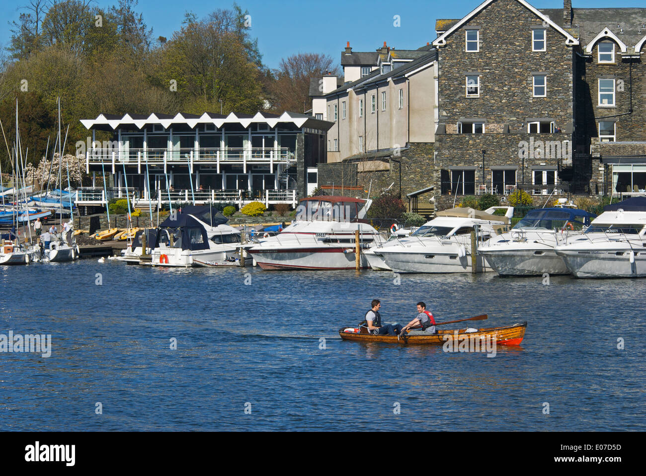 Two young men in dinghy for hire, Lake Windermere at Bowness Bay, Lake