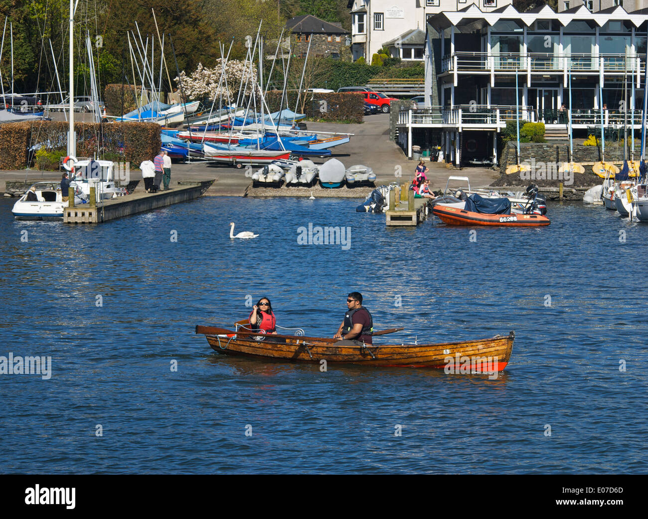 Young Asian couple in dinghy for hire, Lake Windermere at Bowness Bay