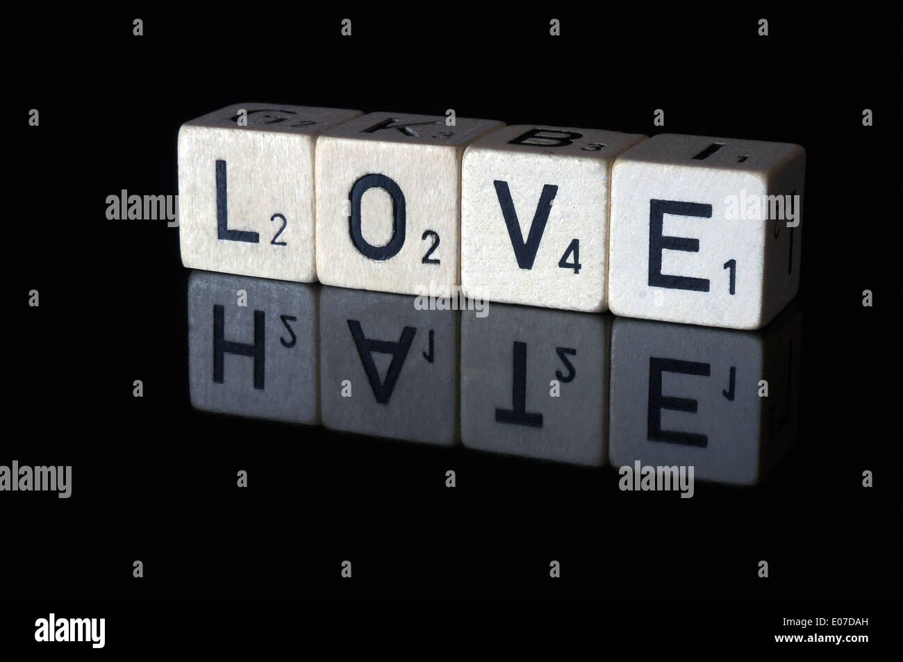 Illustration - Letter cubes read 'Love', which are reflected in a black surface to read 'Hate'. Fotoarchiv für Zeitgeschichte - NO WIRE SERVICE Stock Photo