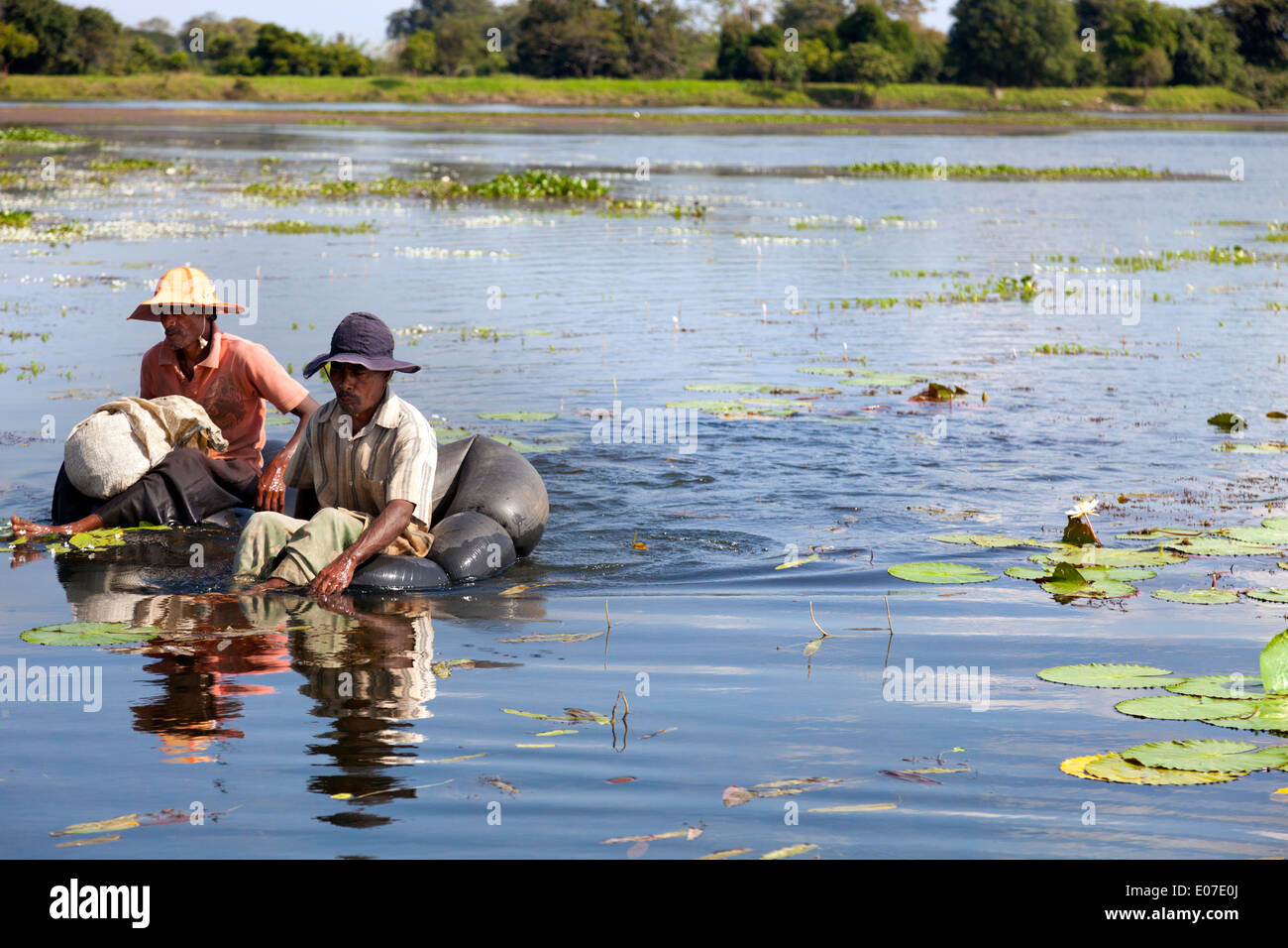 Two unorthodox fishermen paddling in a small lake close to Dambulla, Sri Lanka 2 Stock Photo