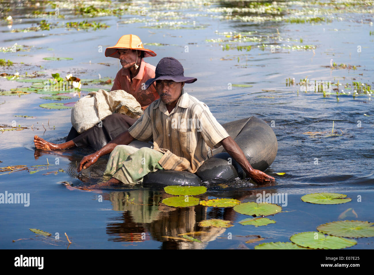 Two unorthodox fishermen paddling in a small lake close to Dambulla, Sri Lanka 5 Stock Photo