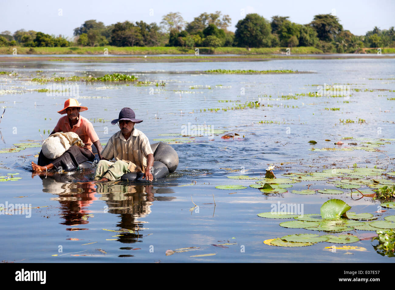 Two unorthodox fishermen paddling in a small lake close to Dambulla, Sri Lanka 1 Stock Photo