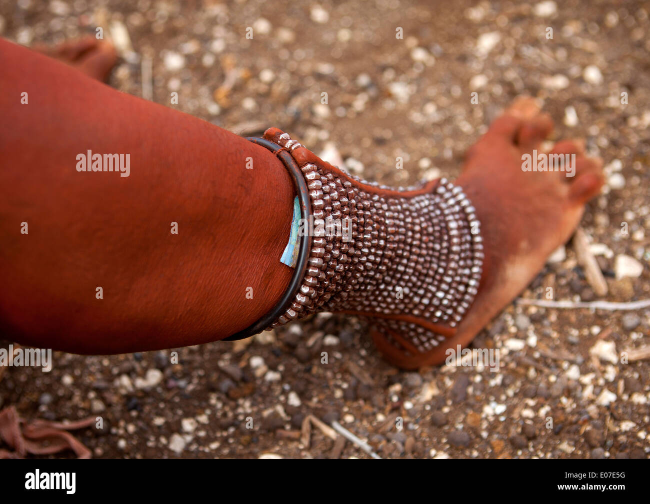 Himba Woman With Beaded Anklets To Protect Their Legs From Venomous Animal Bites, Epupa, Namibia Stock Photo