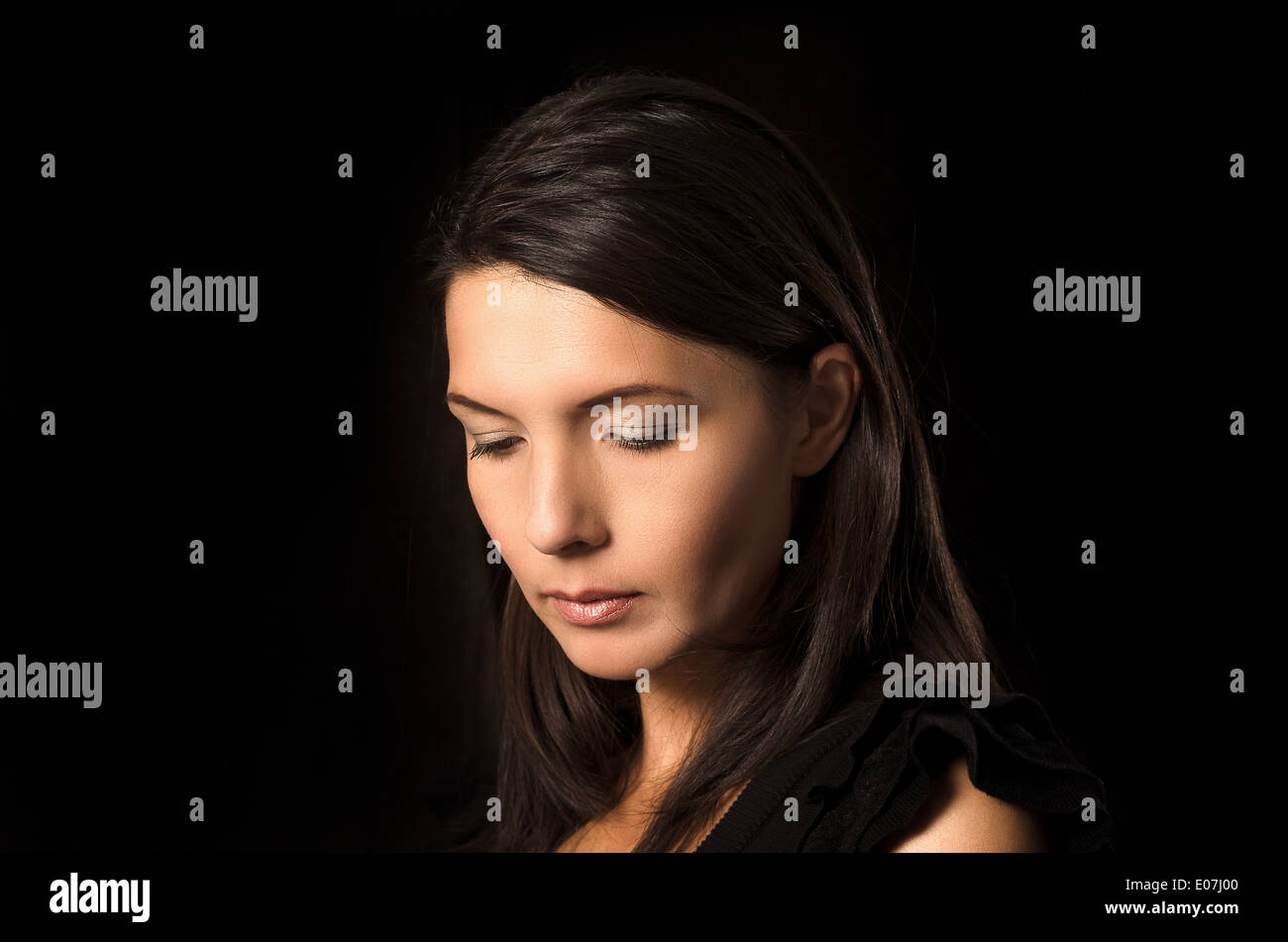 Melancholy woman with a serious expression Stock Photo