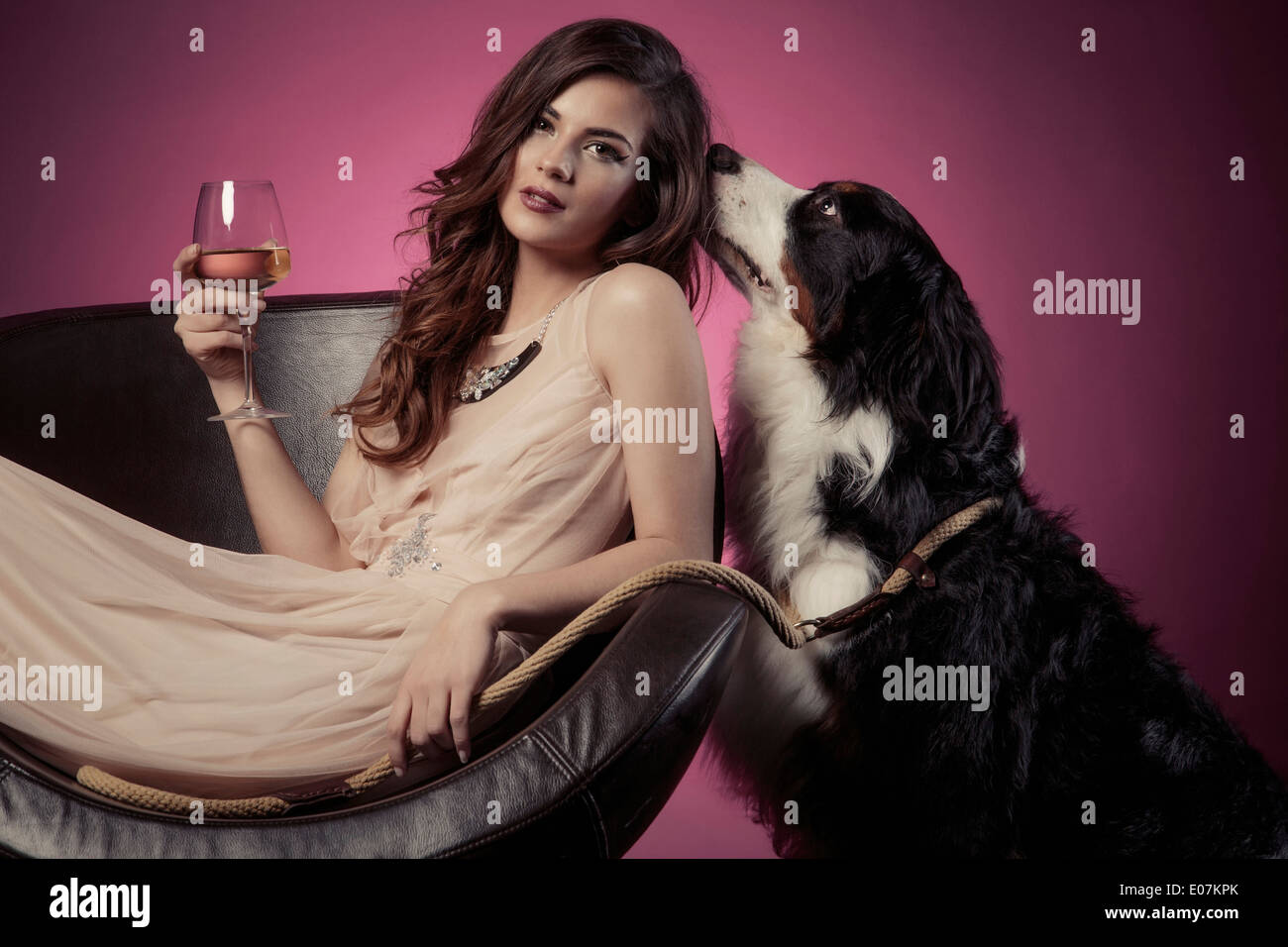 Young woman in evening gown with dog Stock Photo