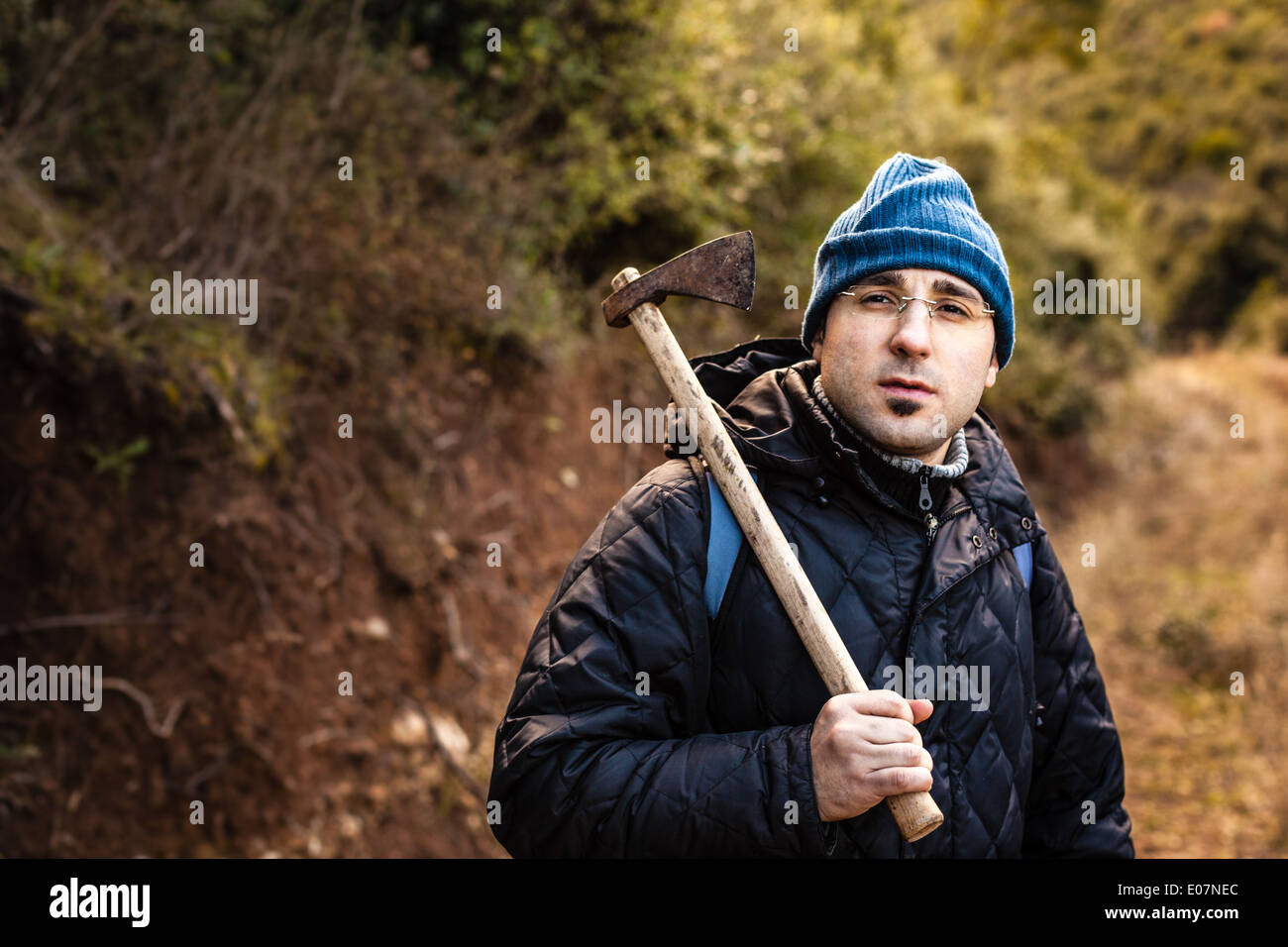 a lumberjack or a psychopath holding a rusty hatchet Stock Photo
