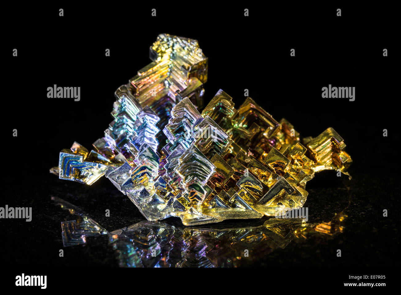 Bismuth metal in front of black Stock Photo - Alamy