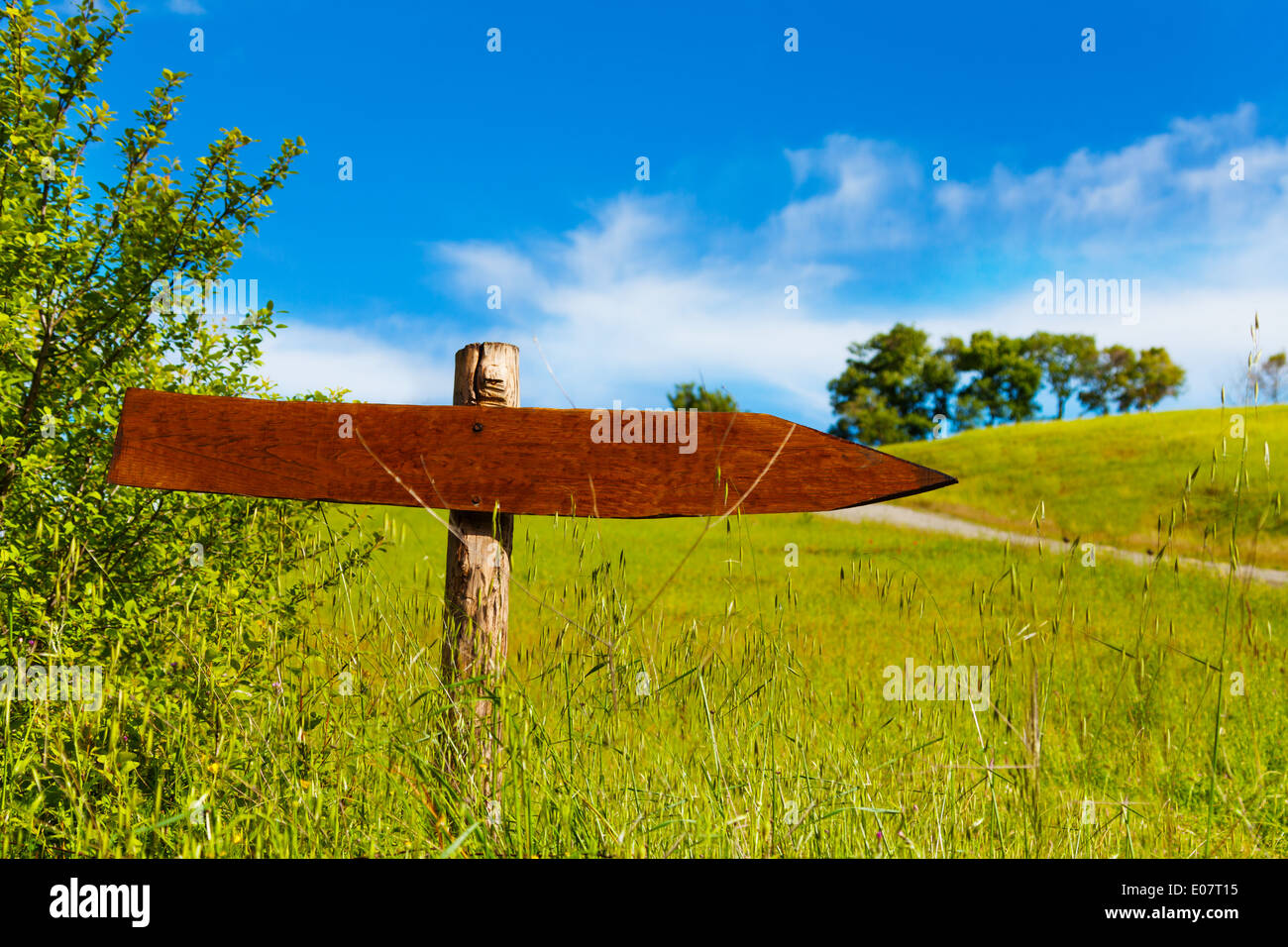 Wooden arrow sign in the valley Stock Photo - Alamy