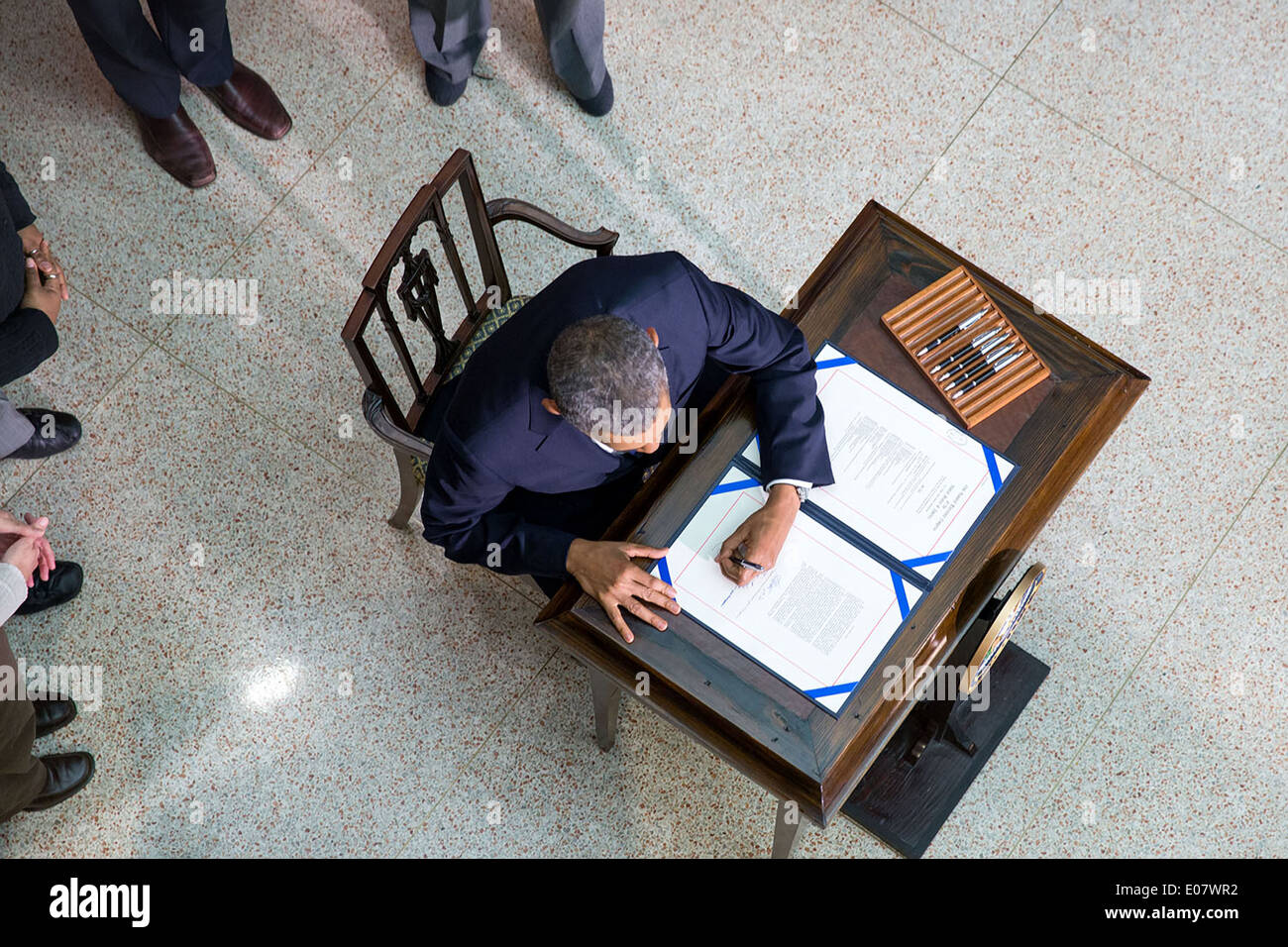 US President Barack Obama signs H.R. 3547, the Consolidated Appropriations Act, 2014, that funds the Federal Government during a signing ceremony in the New Executive Office Building of the White House January 17, 2014 in Washington, DC. Stock Photo