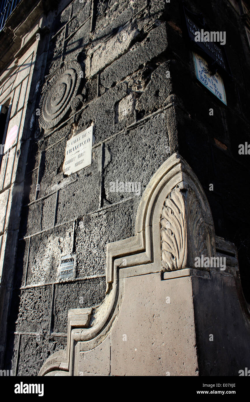Inscriptions and plaque in the wall made of volcanic rock at a street corner along Madero Street, Mexico City, Mexico Stock Photo