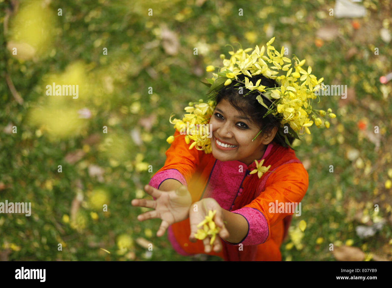 Dhaka, Bangladesh. 5th May, 2014. Dhaka, Bangladesh 05th May 2014;.Bangladeshi girls enjoying with summer flowers in summer season.During summer season many kinds of flowers bloom named Krishnachura (Delonix regia), Sonalu Flower (Cassia fistula), Moulmein Rosewood (Millettia Peguensis), Tropical Crape Myrtle (Lagerstroemia Trubinata) etc. © Zakir Hossain Chowdhury/NurPhoto/ZUMAPRESS.com/Alamy Live News Stock Photo