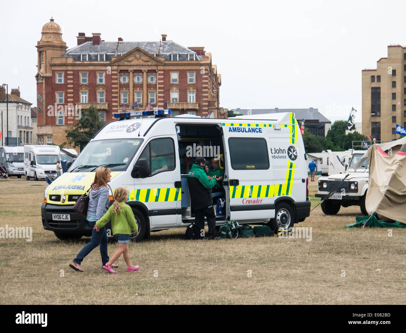 Members of St. John Ambulance providing emergency first aid cover from an ambulance at a community event. Stock Photo