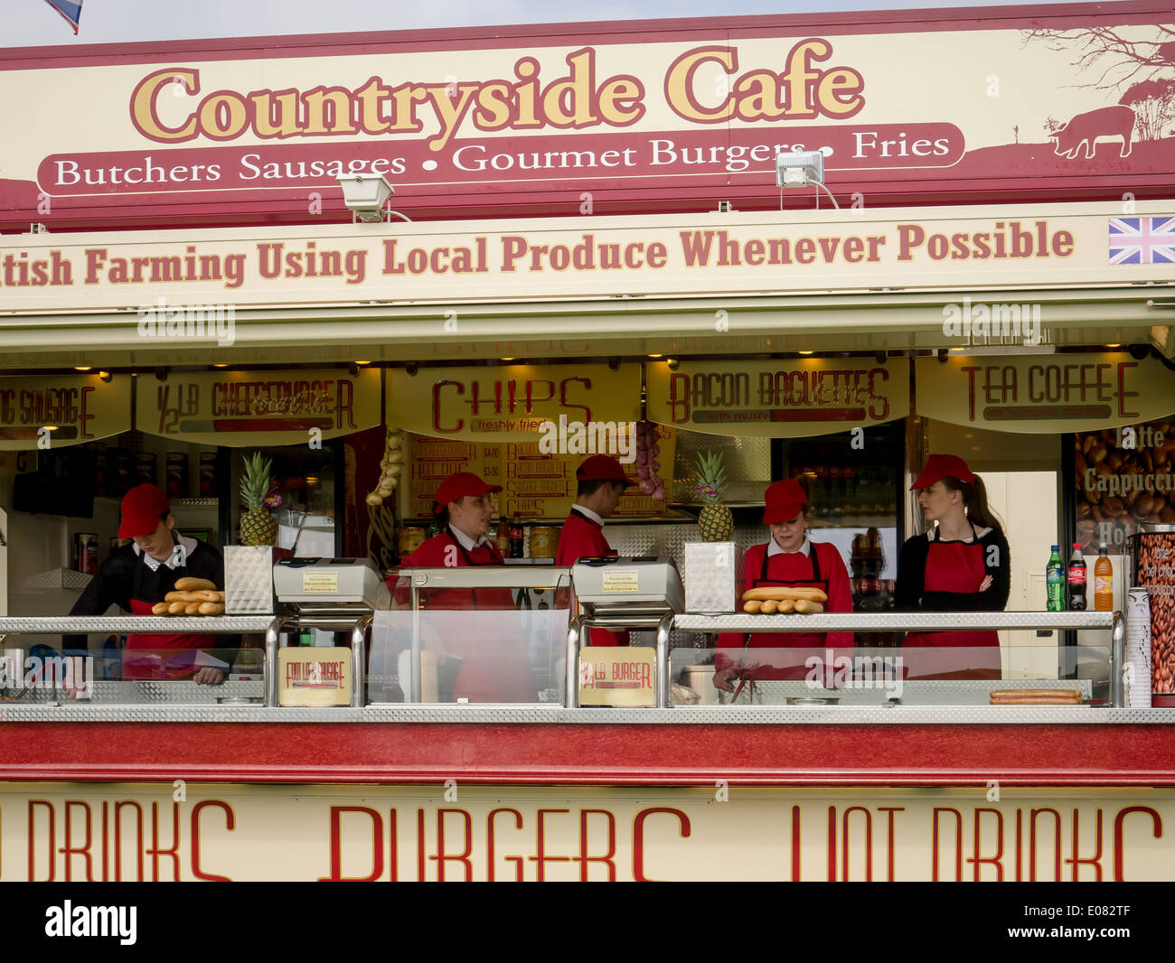 Caterers at mobile catering unit await customers at a summer festival Stock Photo
