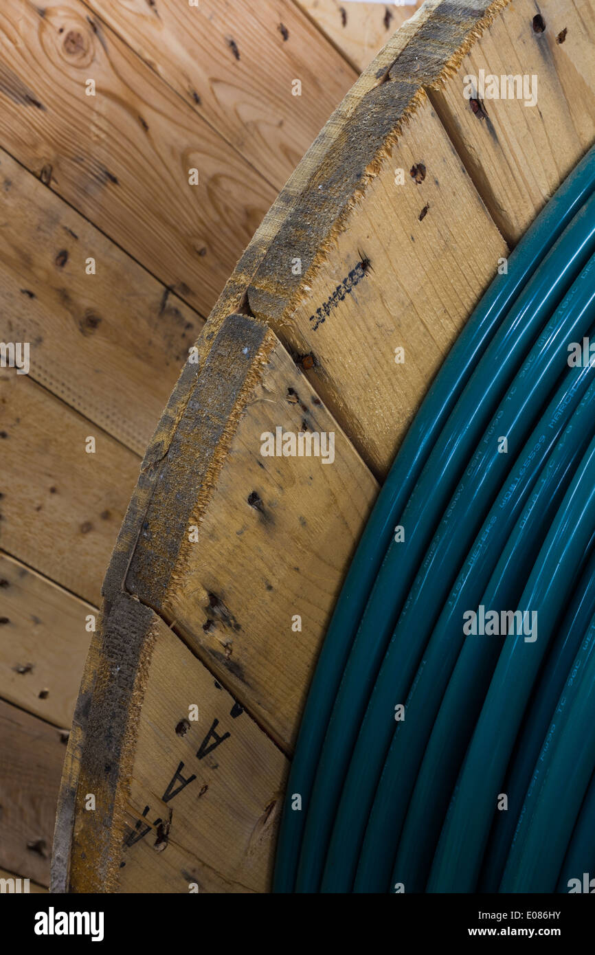 Partial view of electrical cable on a large wooden drum Stock Photo