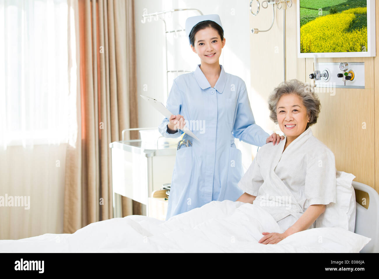 Nurse helping senior woman doing rehabilitation training Stock Photo