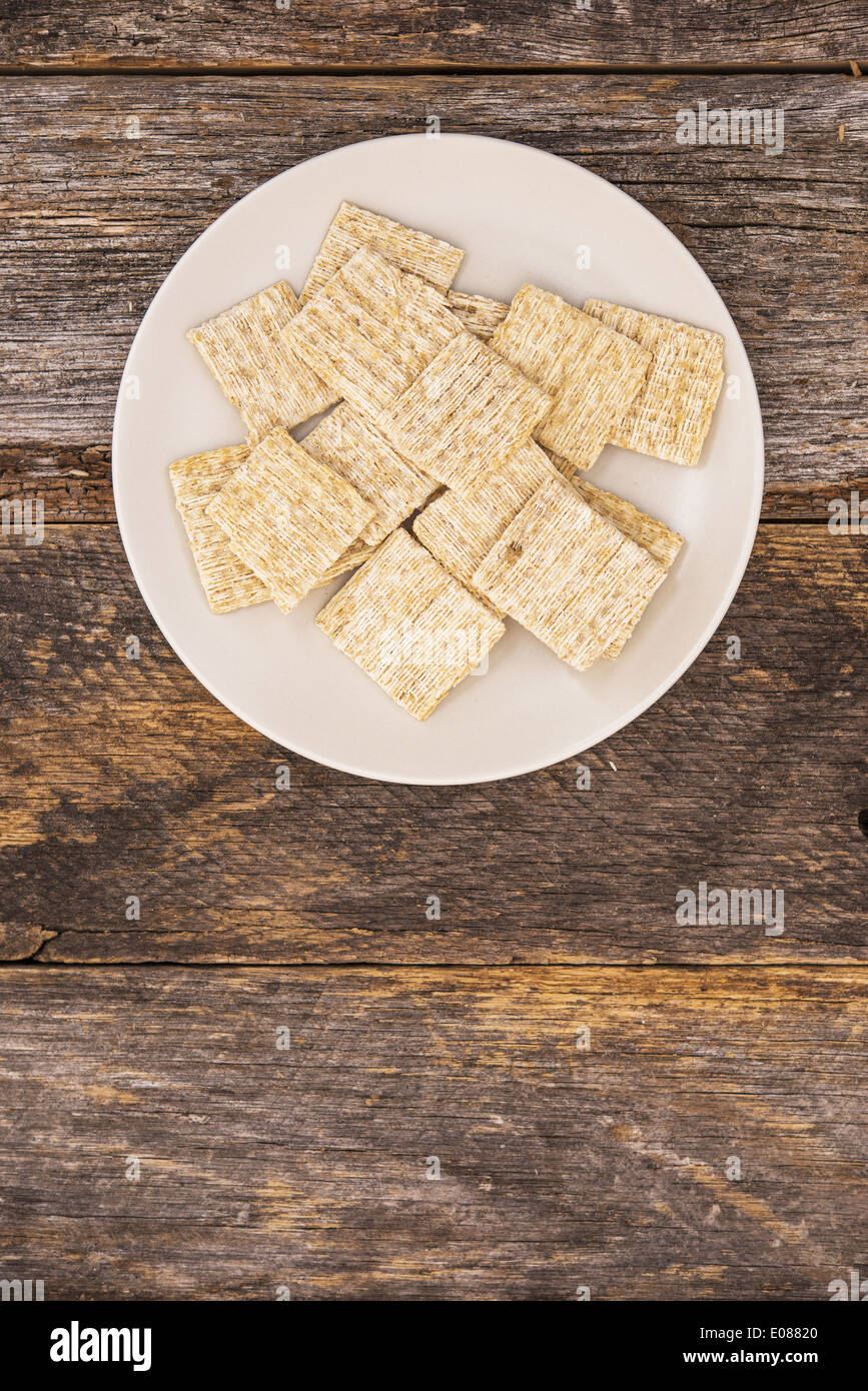 Baked Woven Wheats. Whole Wheat Crackers on Wooden Table Stock Photo