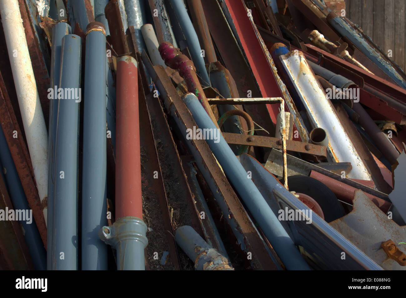 Reclaimed cast iron gutter and downpipe sections for recycling and reuse on repair and replacement work Stock Photo