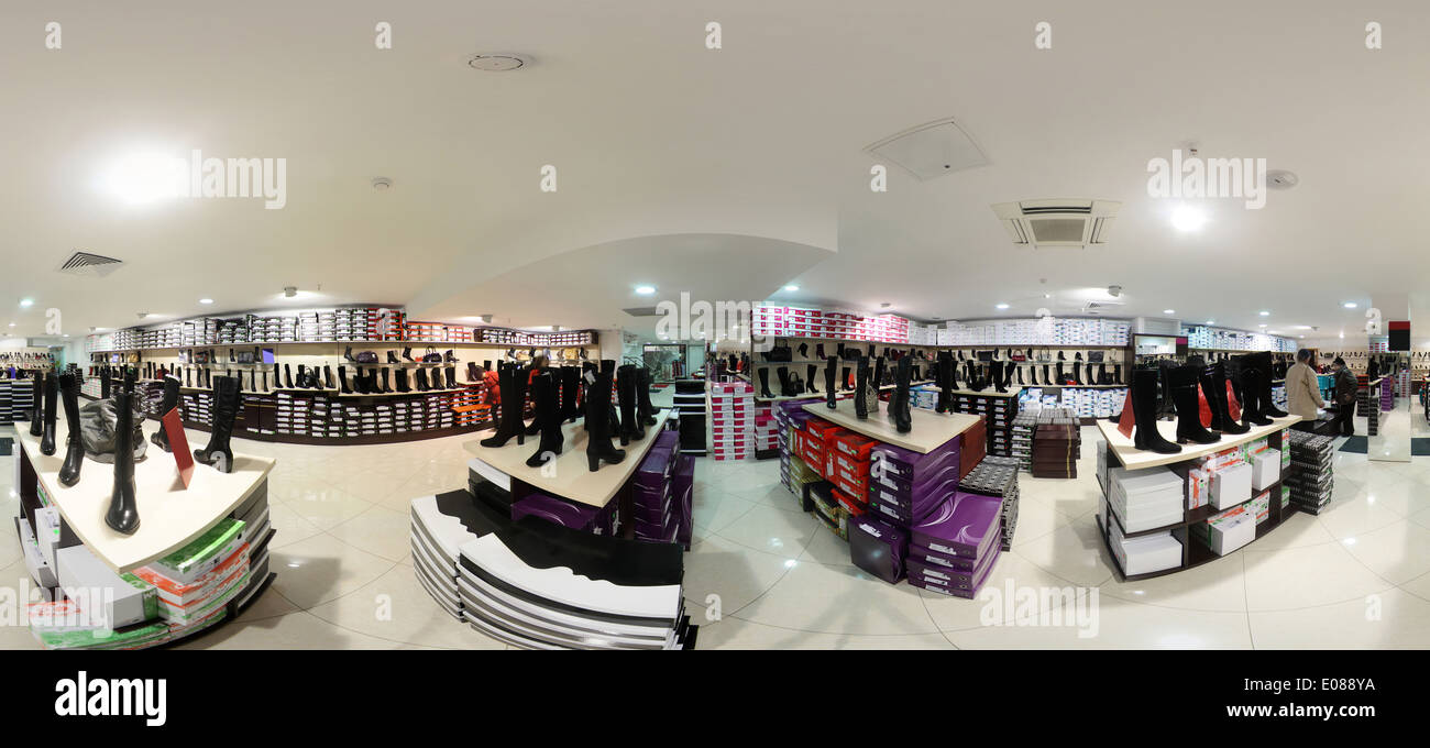 bright and fashionable interior of shoe store in modern mall Stock
