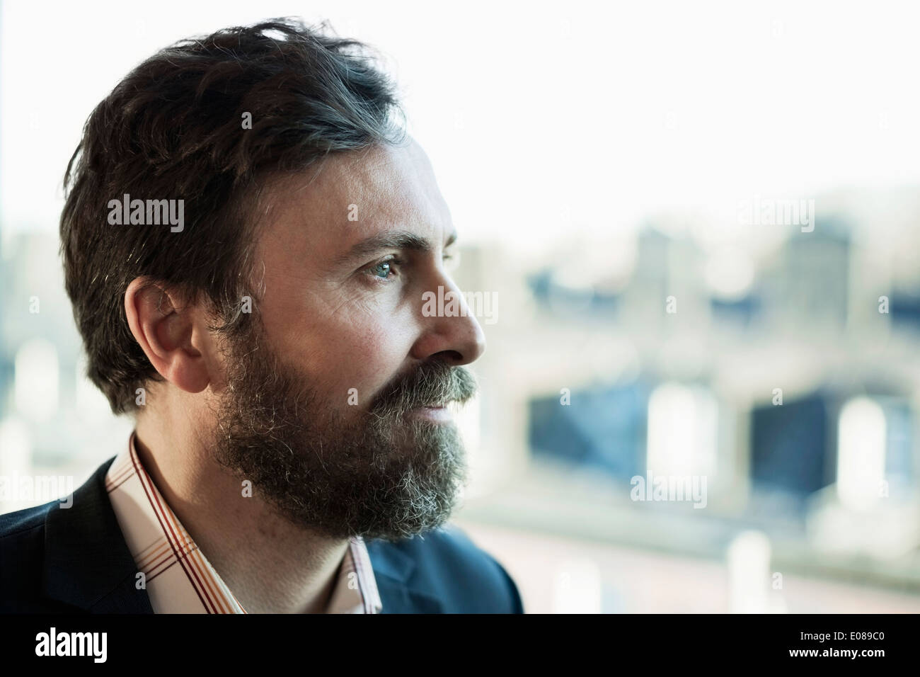 Thoughtful businessman looking away outdoors Stock Photo