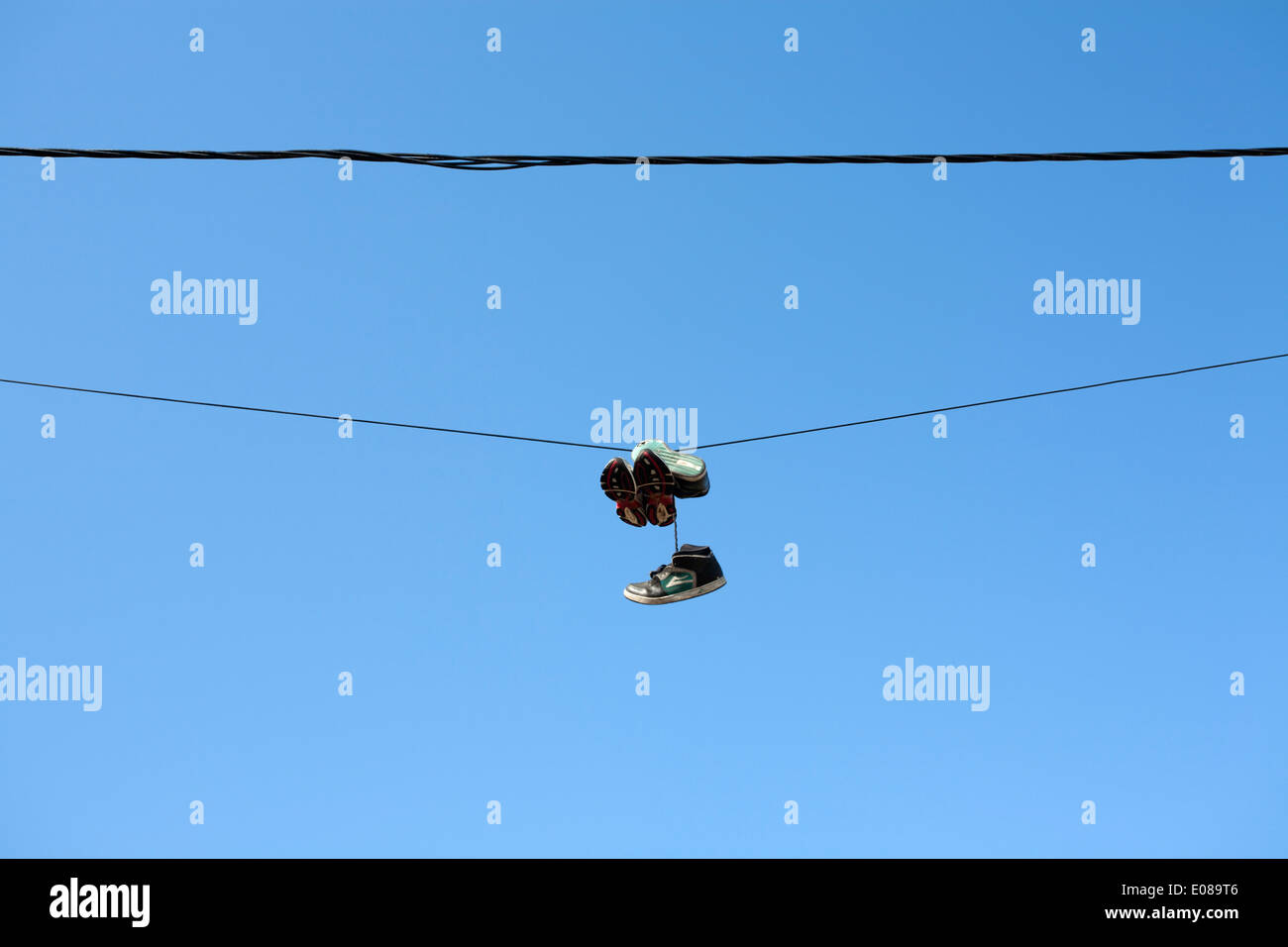 Two pairs of shoes lay on the wooden floor of - stock photo