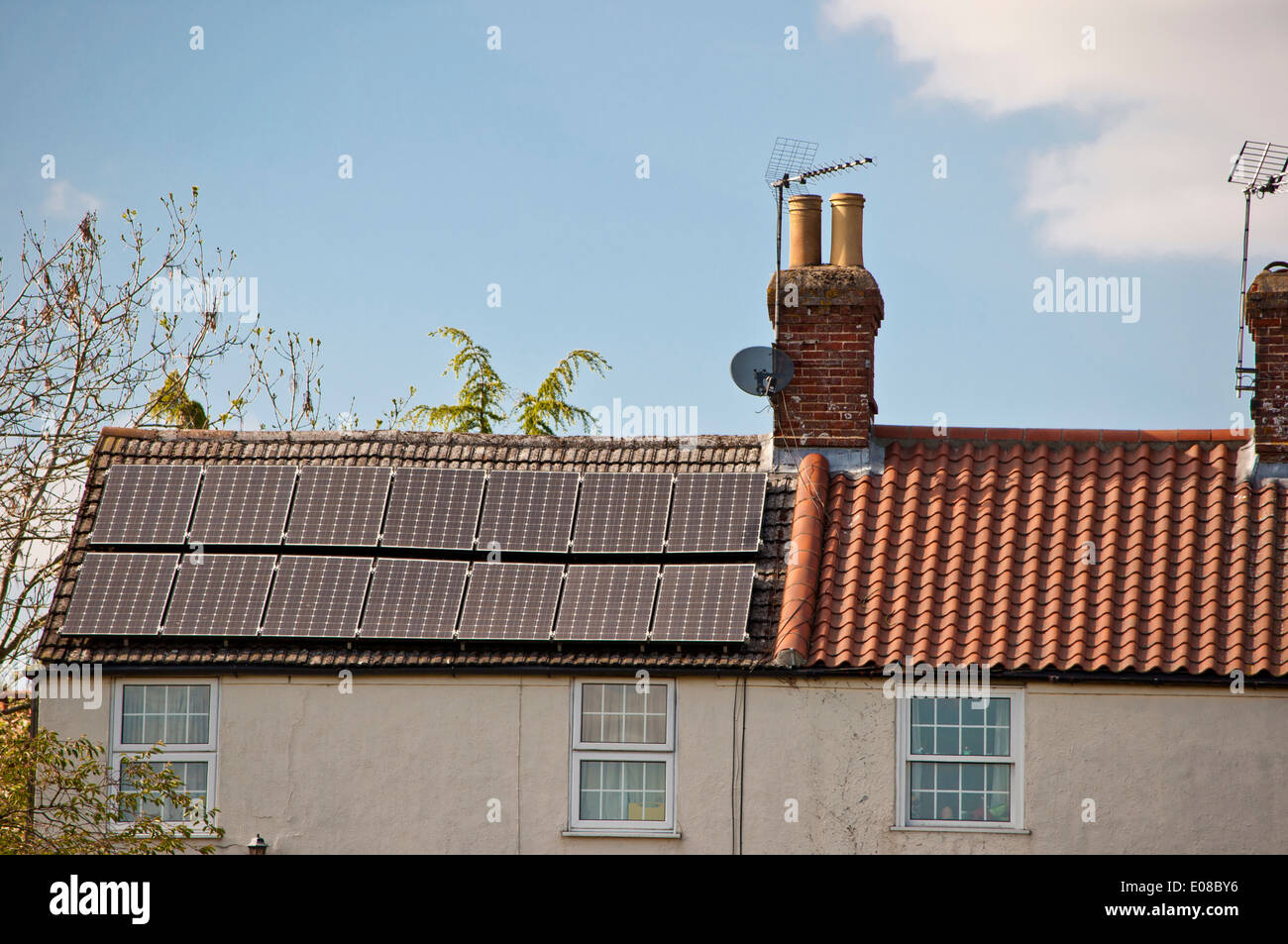 Solar roof panels on old rural county house cottage Stock Photo
