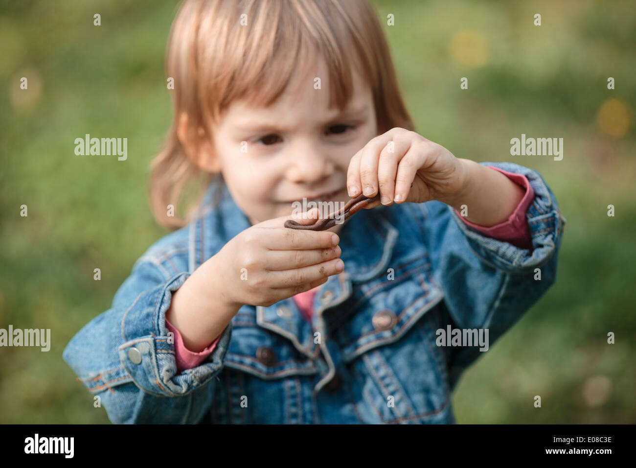 Little girl holding leaf in hands, portrait Stock Photo - Alamy