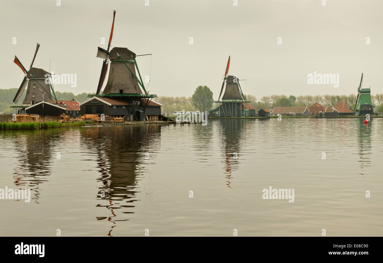 DUTCH WINDMILLS AND CANAL AT ZAANSE SCHANS WITH ORANGE SAILS HOLLAND Stock Photo